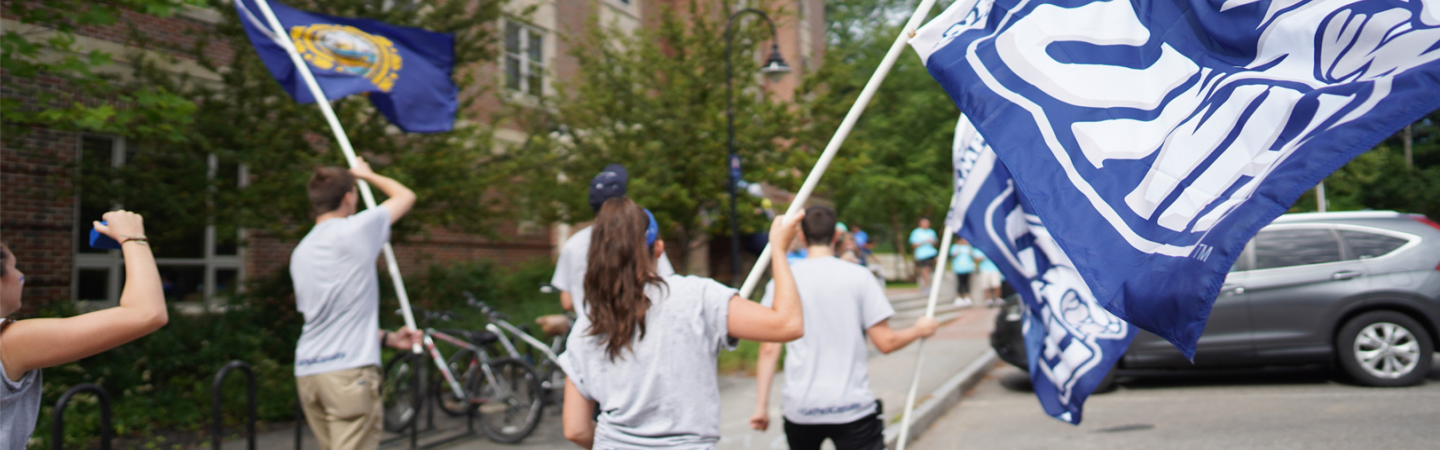 UNH students with flags