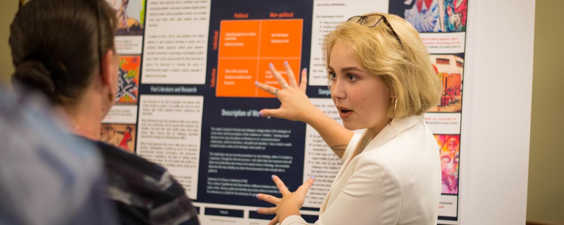 UNH student discussing research project