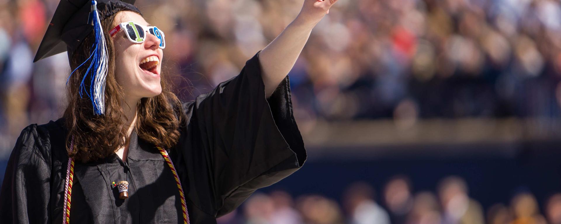 Female student cheering at graduation