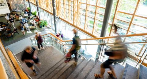 UNH students walking to class in great hall of Paul College