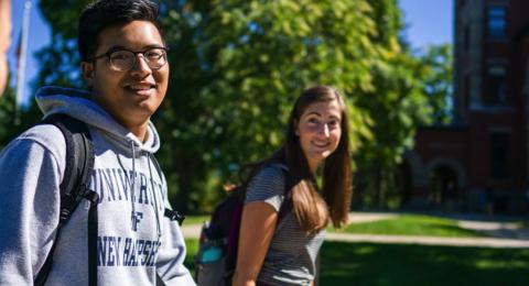 UNH students walking outside on campus