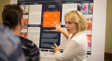 UNH student discussing research project