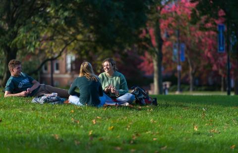 students sitting on the lawn at UNH