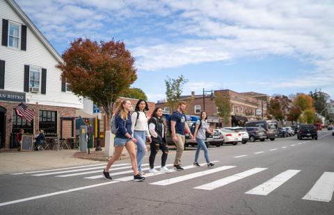 UNH students walking across Main Street