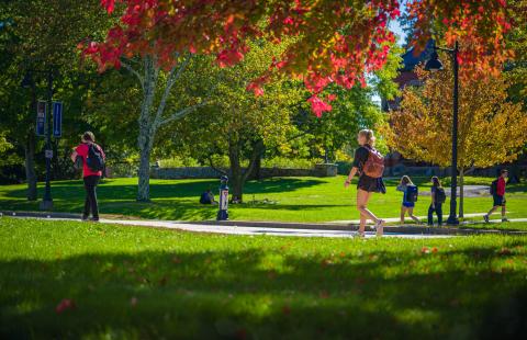 UNH students walking on campus in fall