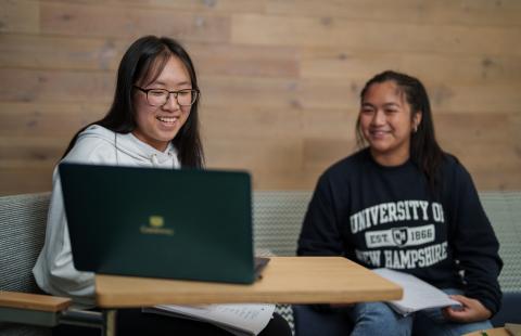UNH students studying on a laptop