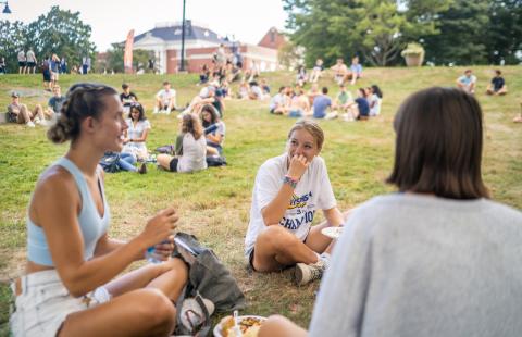UNH students relaxing on the lawn in the Fishbowl