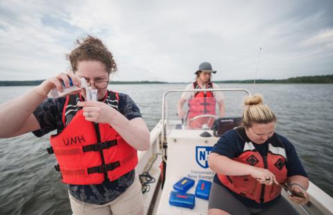 UNH undergraduate researchers examining eastern oysters in early larval stages in the Great Bay Estuary 