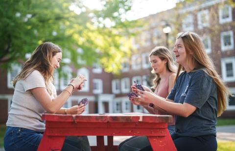 UNH students playing cards outside 