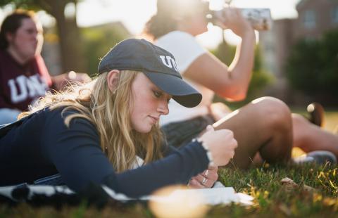 UNH student on T Hall lawn