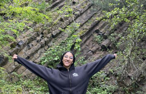 UNH student by rocks