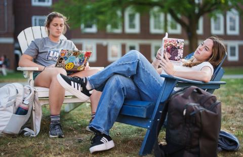 UNH students hanging out outdoors on campus