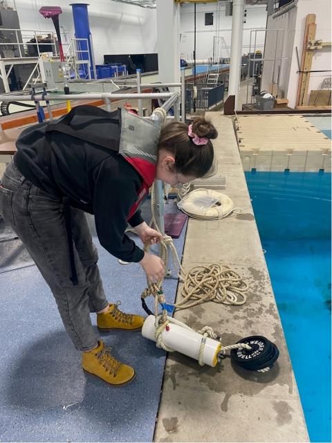 UNH ocean engineering student prepares to test the waterproof seal on research project