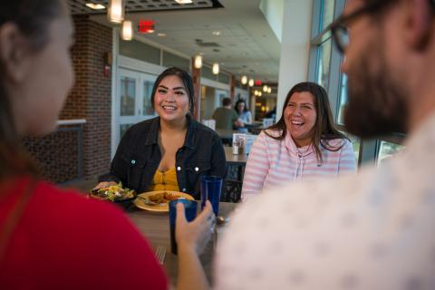 Enjoying food with friends at Holloway Commons dining hall.