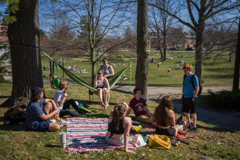 UNH students enjoying the warm weather on campus 