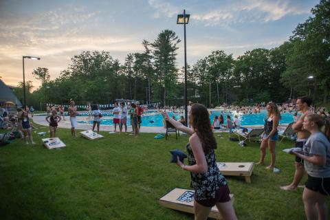 Playing games at summer orientation by the outdoor pool
