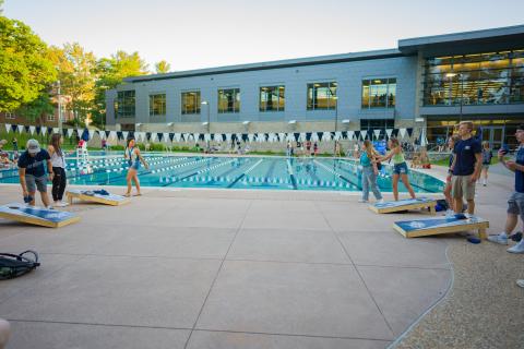 Playing games by the outdoor pool at June orientation