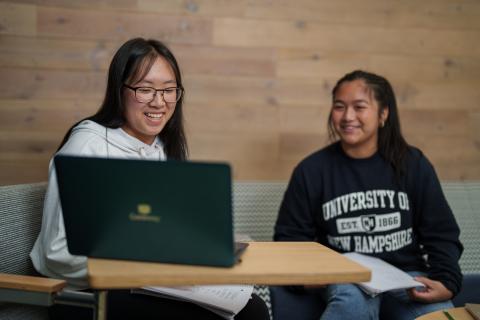 UNH students studying on a laptop
