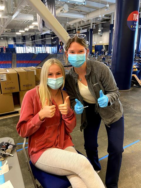 two UNH students at vaccine clinic