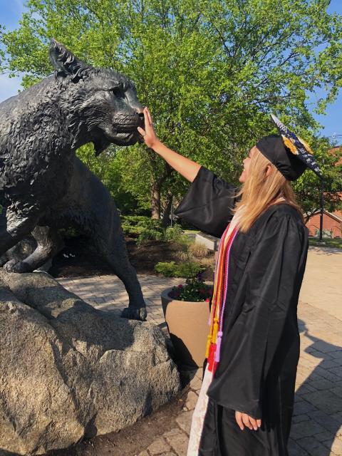 UNH student and wildcat statue