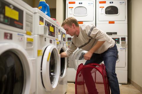 UNH student doing laundry in residence hall 
