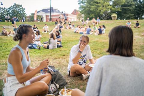 UNH students relaxing on the lawn in the Fishbowl