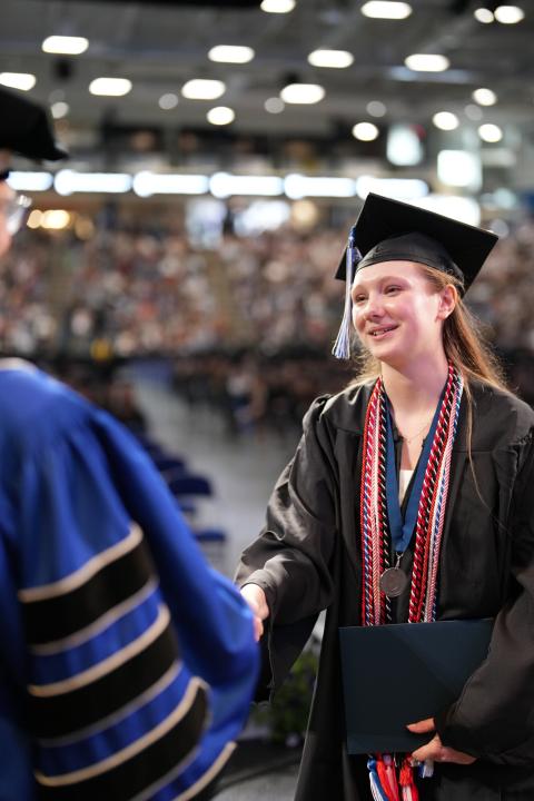 Emma receiving her degree at commencement