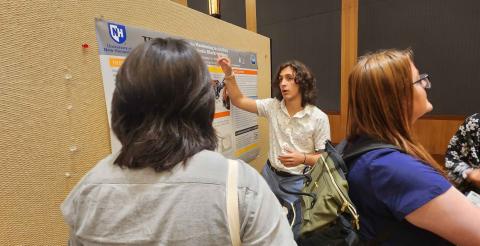 Pedro presenting research to other McNair scholars from across the country
