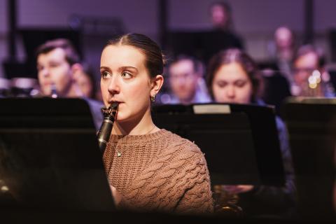 UNH student playing clarinet in musical ensemble
