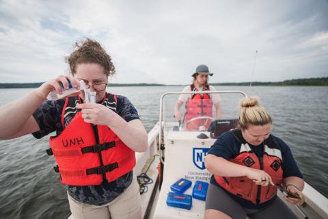 UNH undergraduate researchers examining eastern oysters in early larval stages in the Great Bay Estuary