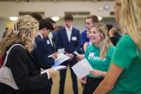 UNH student speaking with representatives from Fidelity Investments at the Career and Internship Fair
