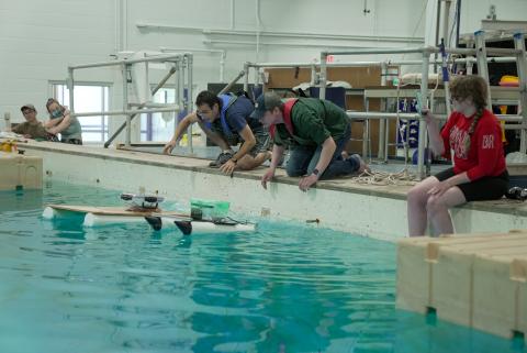 UNH students demonstrating robots in the Chase Ocean Engineering Laboratory.