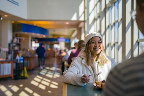 UNH student eating in HoCo