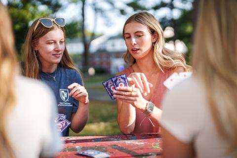 UNH students hanging out outdoors on campus