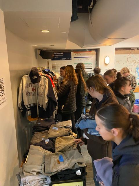 UNH students looking through clothing at the MUB Underground event