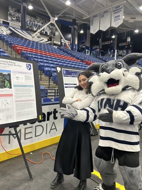 Wild E. Cat posing with Jordan in front of her poster.