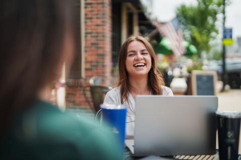UNH student working on laptop outside