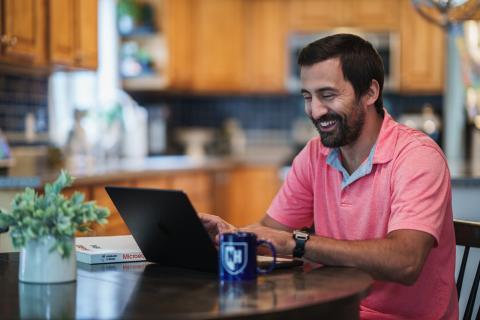 UNH student working on laptop