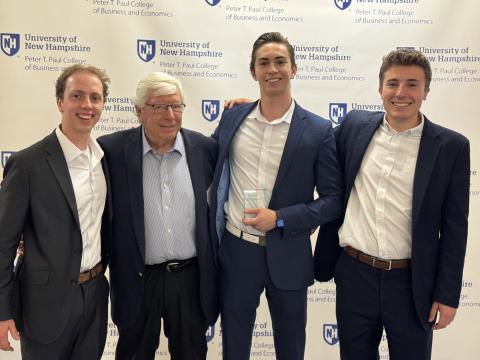 UNH students posing with Peter T. Paul