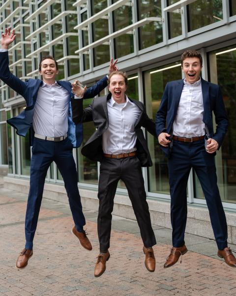 UNH students jumping in the air