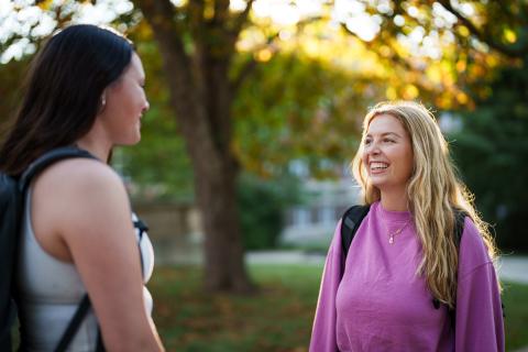 UNH students hanging out outdoors on campus