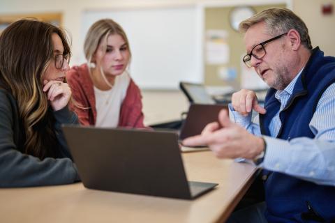 UNH professor working with students in class