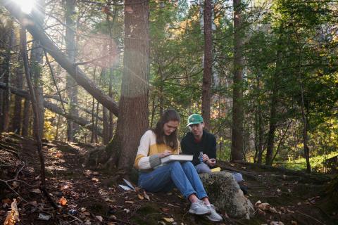UNH College of Life Sciences and Agriculture students doing fieldwork by the Oyster River 